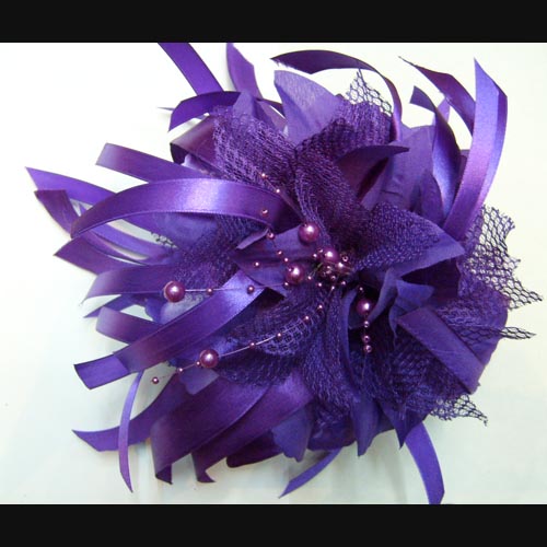 hair clip is made of fabric flower and ribbon.